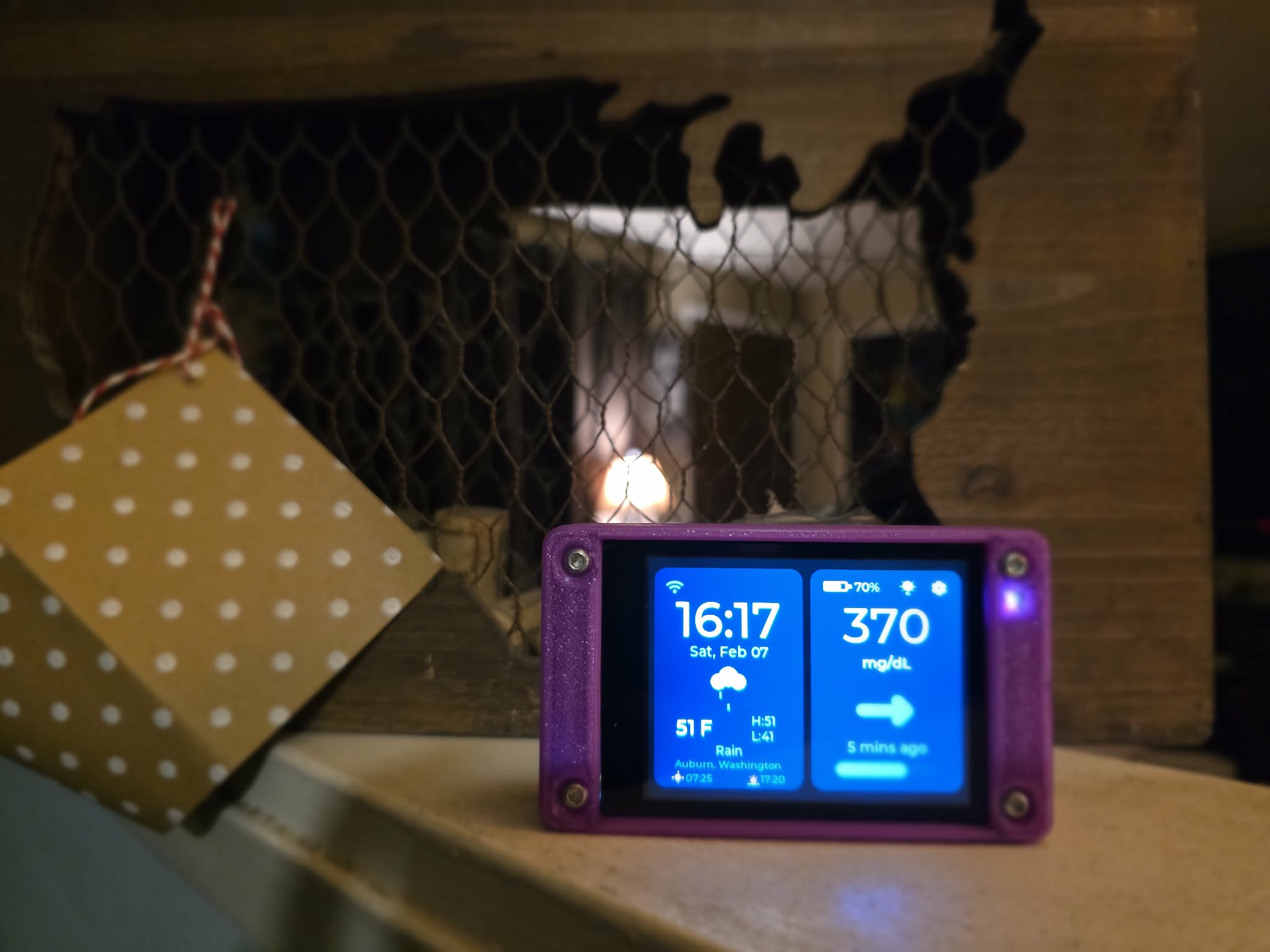 CYGM device in purple case on a mantle
